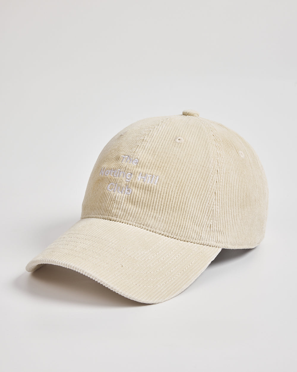 Cream cap with text on a light gray background