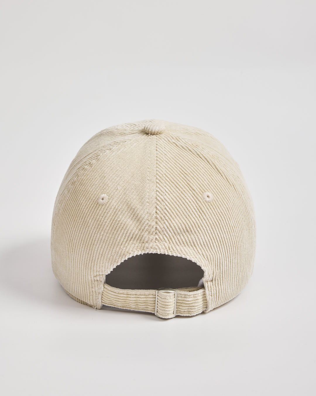 Cream corduroy cap on a light gray background