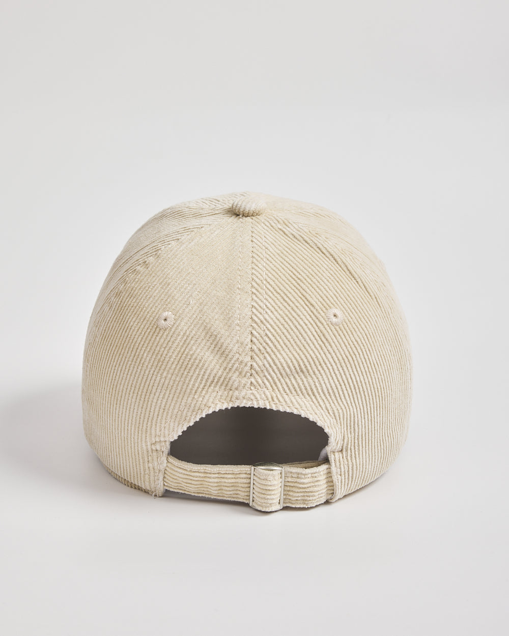 Cream corduroy cap on a light gray background