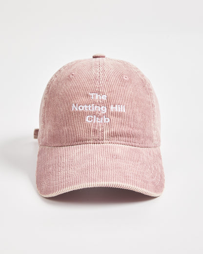 Pink cap with 'The Notting Hill Club' text on a light gray background