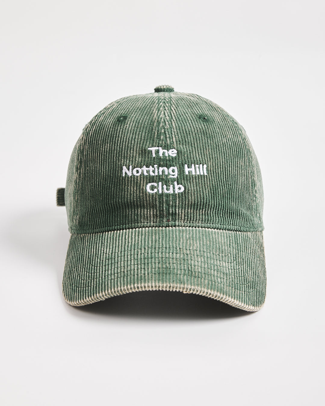Green cap with 'The Notting Hill Club' text on a white background
