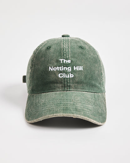 Green cap with 'The Notting Hill Club' text on a white background