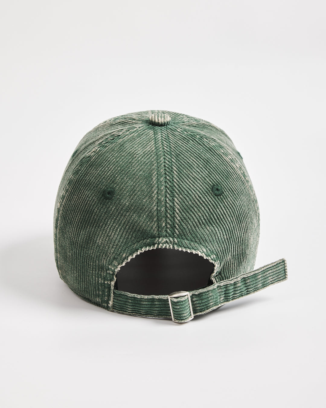 Green corduroy cap on a white background