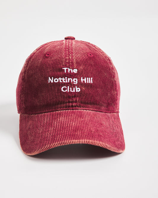 Red cap with 'The Notting Hill Club' text on a white background
