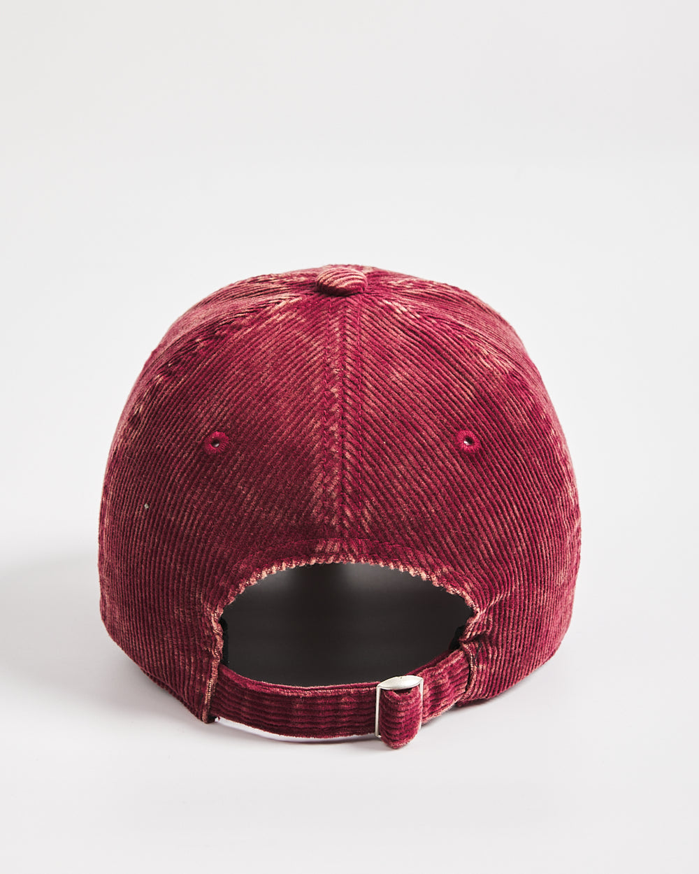 Maroon corduroy cap on a light gray background