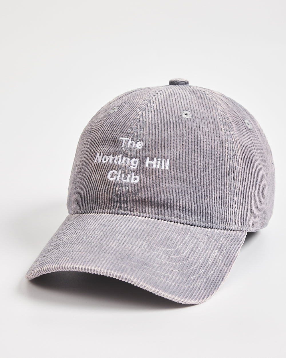 Gray corduroy cap with 'The Notting Hill Club' text on a white background
