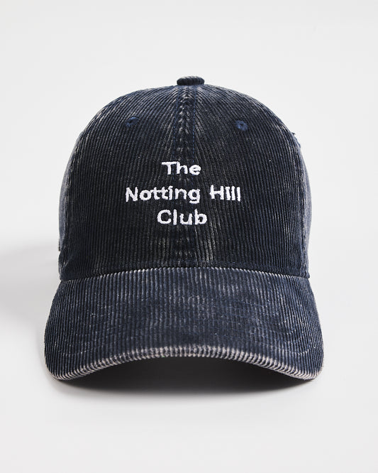 Navy corduroy cap with 'The Notting Hill Club' text on a white background
