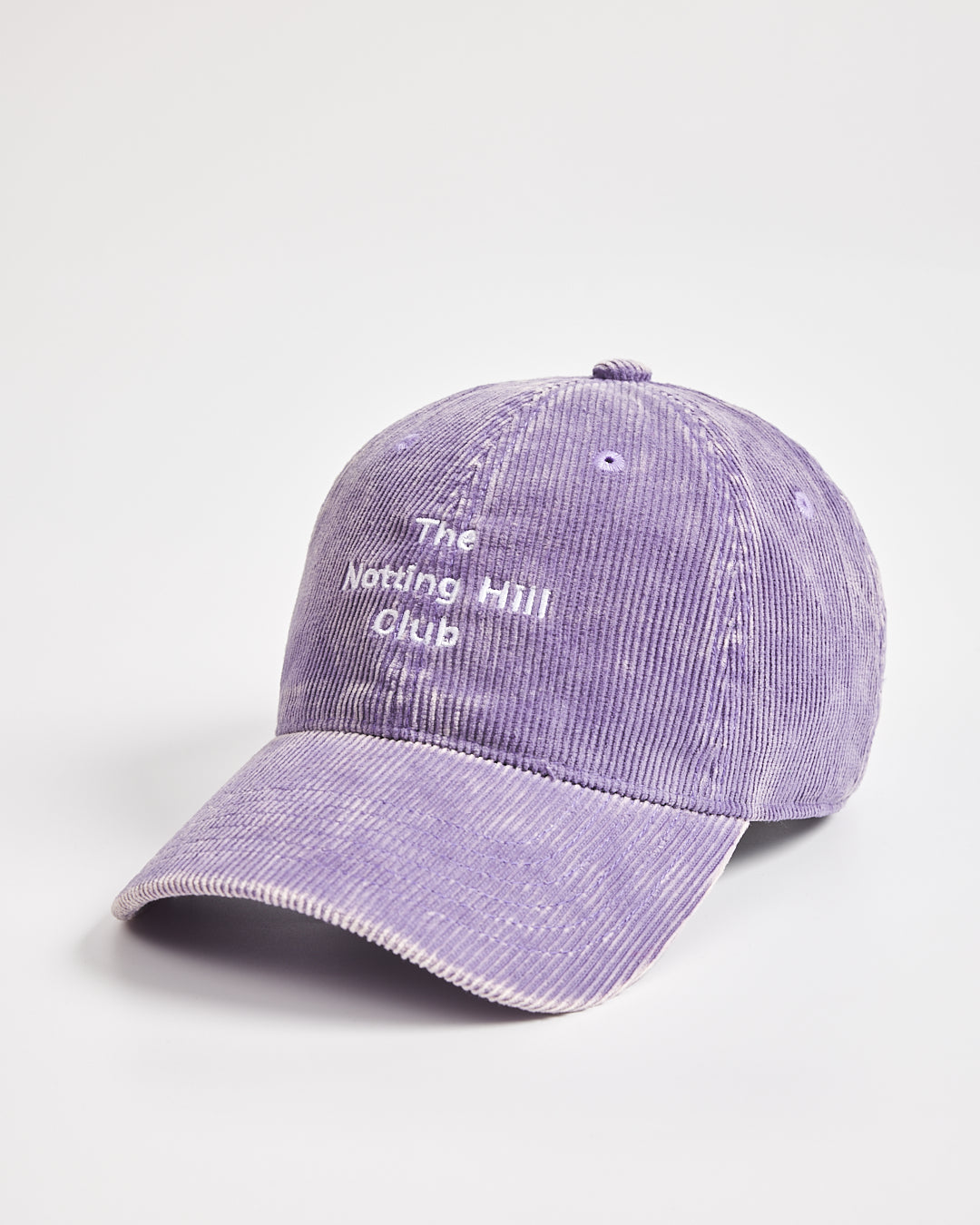 Purple cap with 'The Notting Hill Club' text on a light gray background