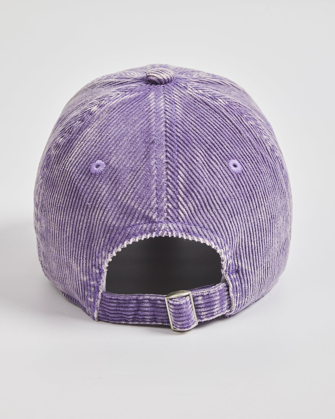 Purple corduroy cap on a light gray background