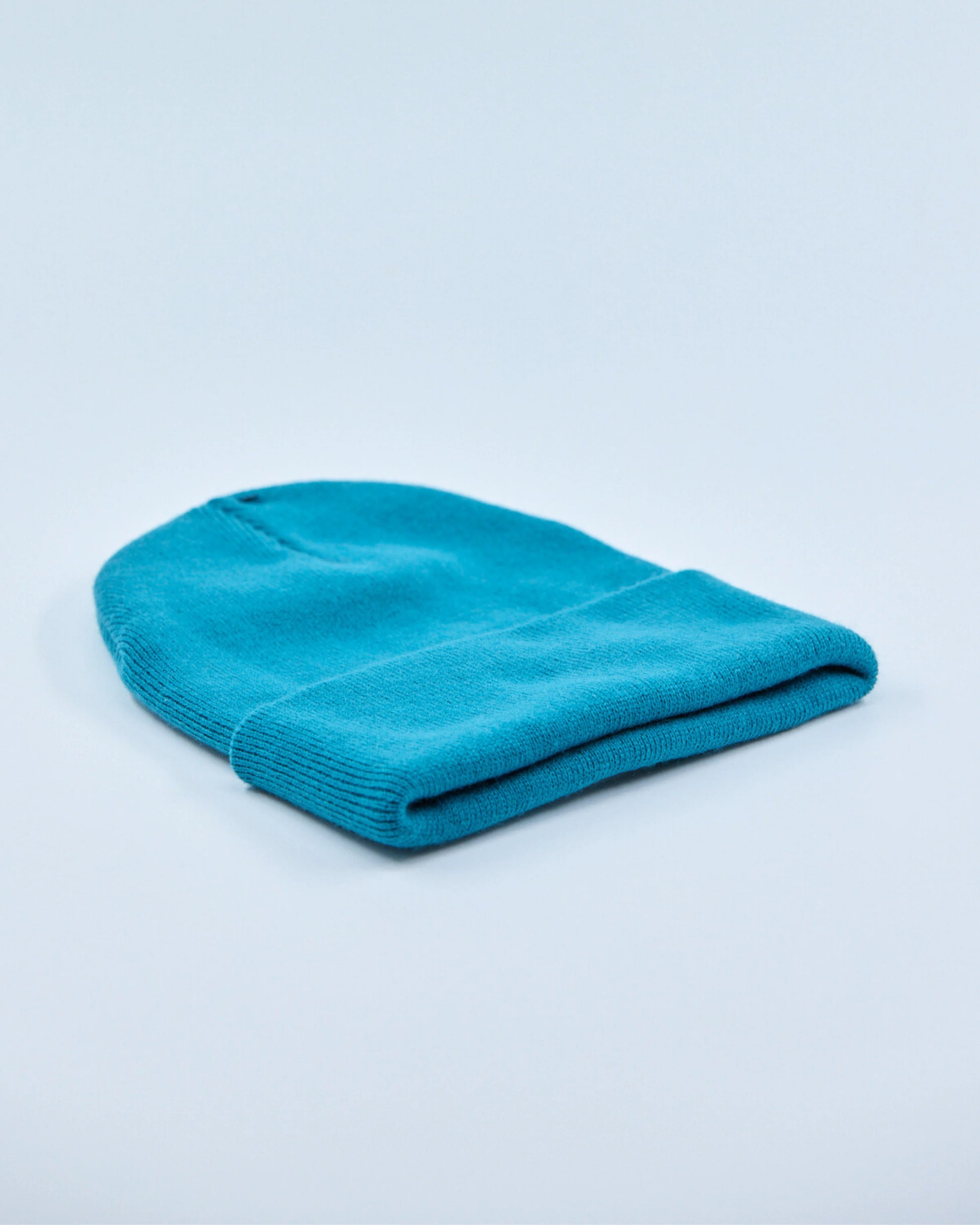 Ocean teal beanie on a light blue background