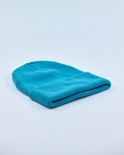 Ocean teal beanie on a light blue background