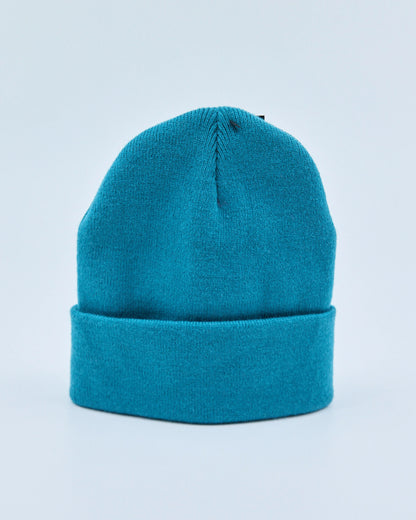Ocean teal beanie on a light blue background