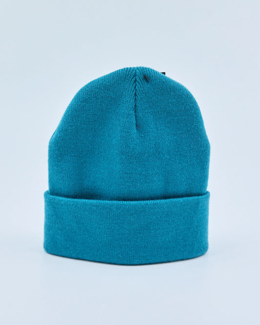 Ocean teal beanie on a light blue background