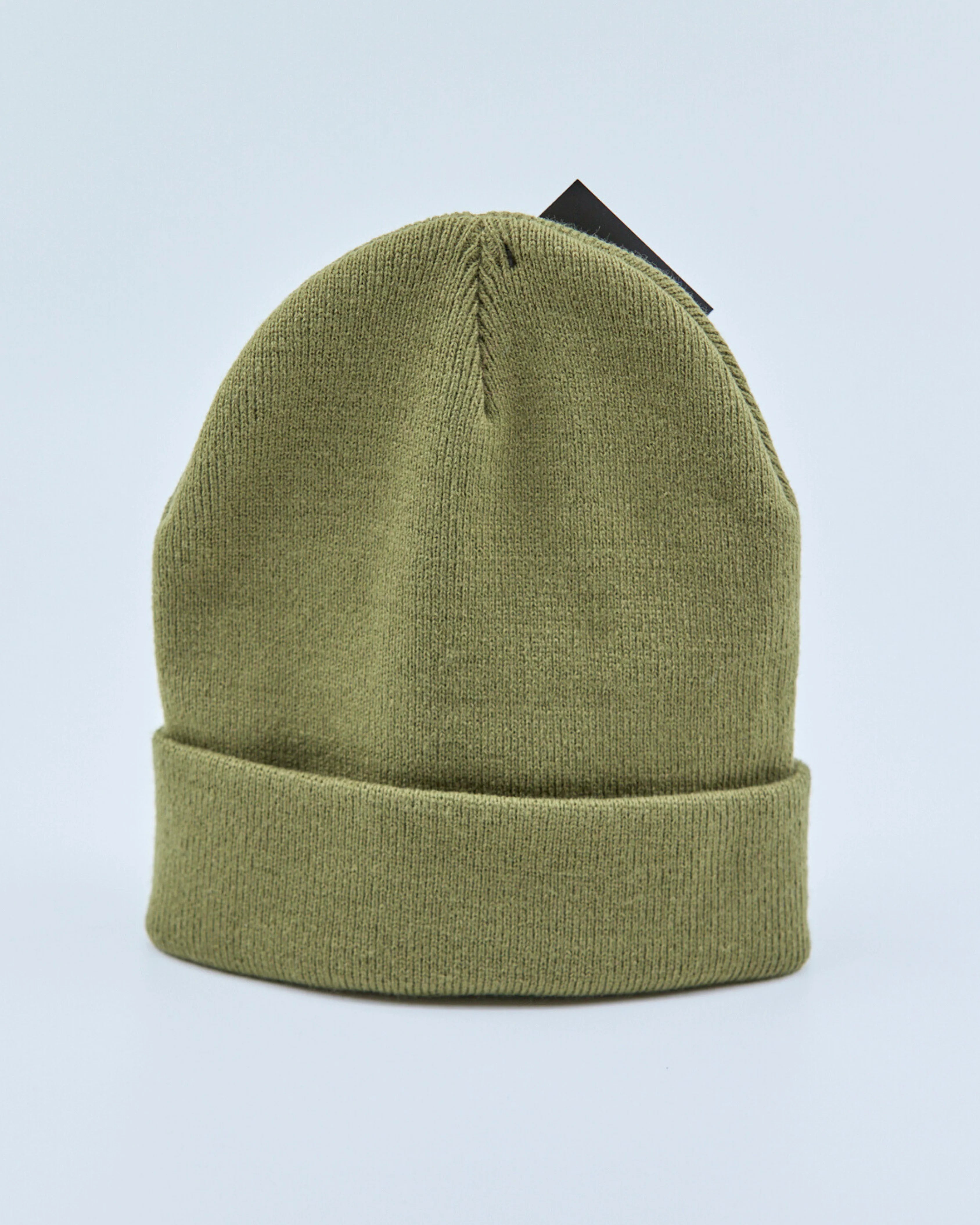 Olive green beanie on a light blue background