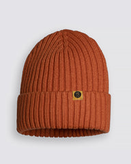 Orange knit beanie with a logo tag on a light gray background