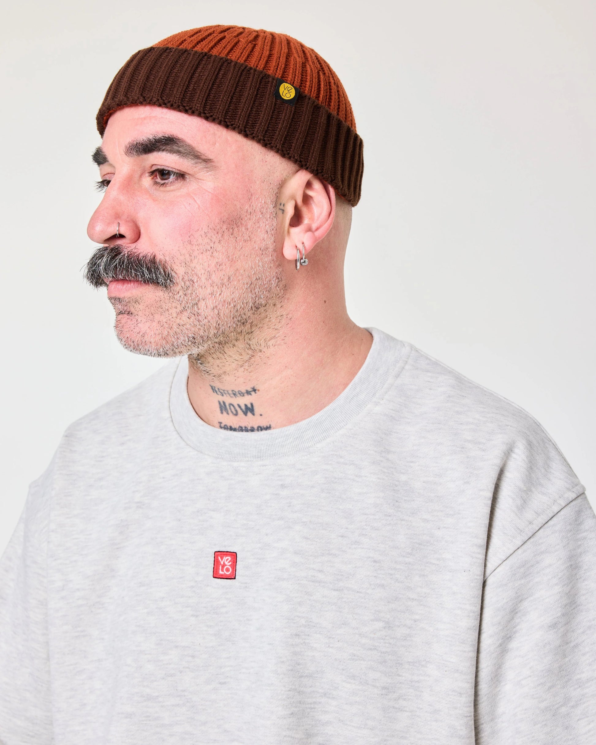 side view of a man wearing Orange Crochet Pattern Fisherman Beanie