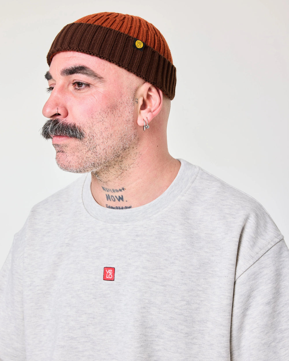 side view of a man wearing Orange Crochet Pattern Fisherman Beanie
