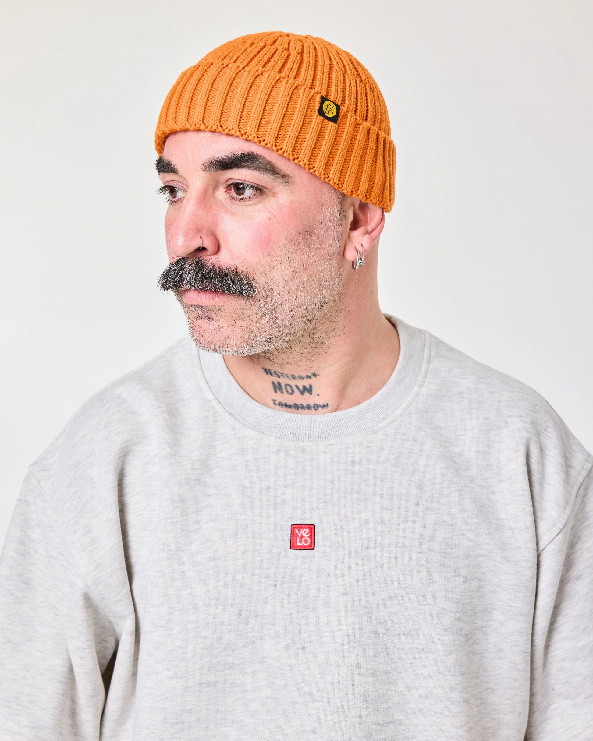 side view of a man wearing Orange Fisherman Beanie