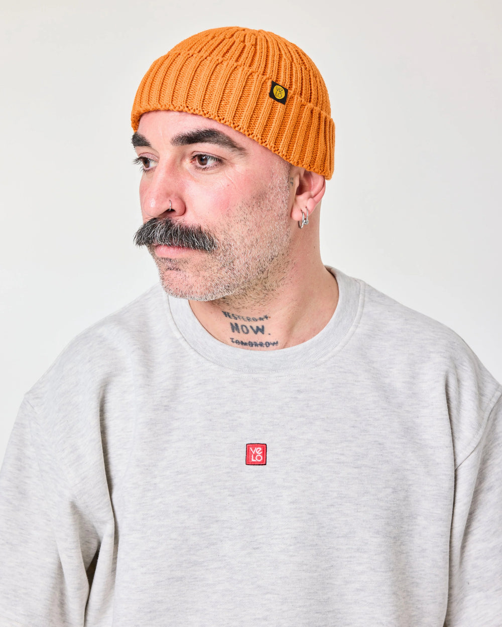 side view of a man wearing Orange Fisherman Beanie