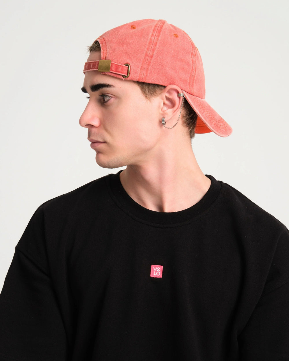 side view of a man wearing Love You Bye Orange Washed Cap Hat