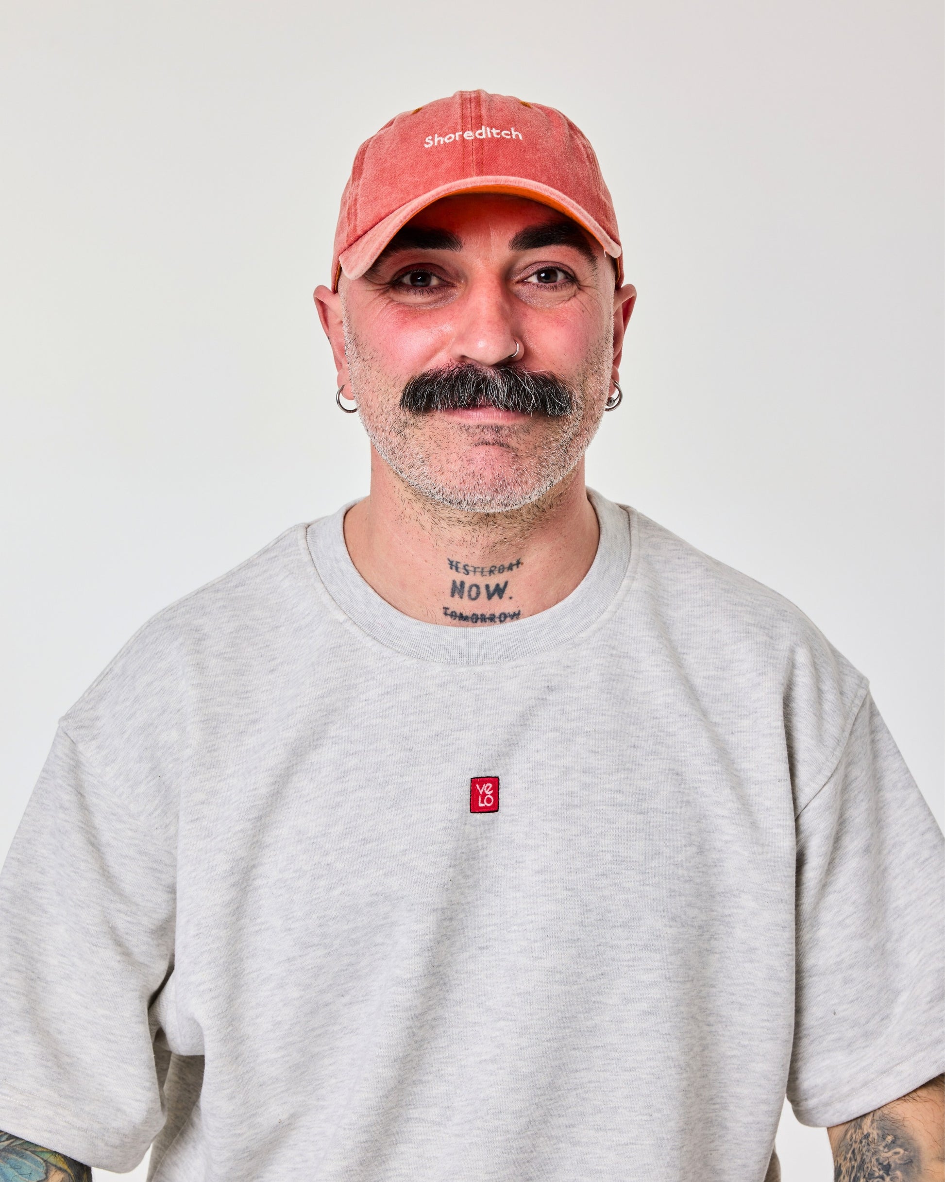 front view of a man wearing Shoreditch Orange Washed Cap