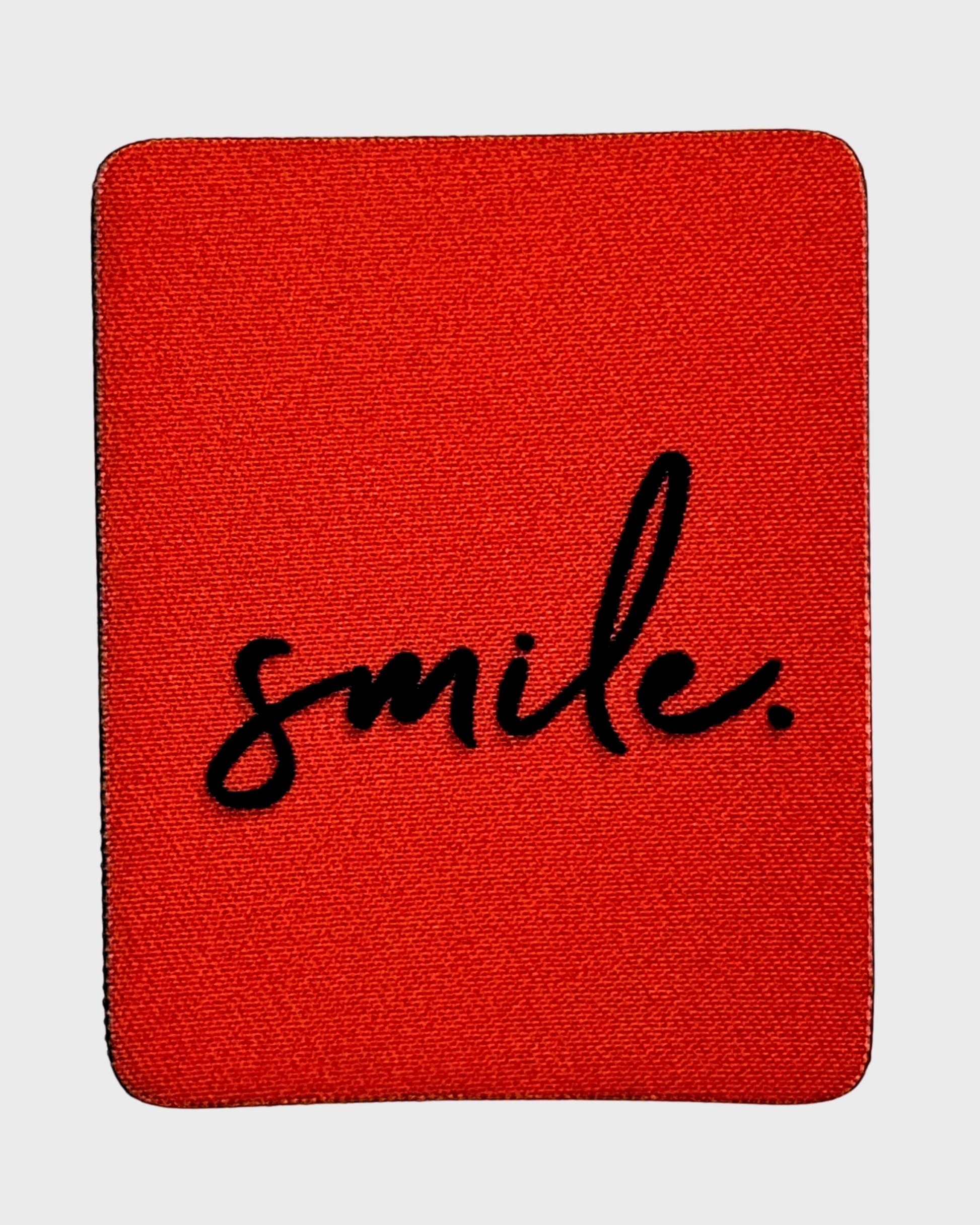 Orange fabric patch with 'smile.' text on a white background