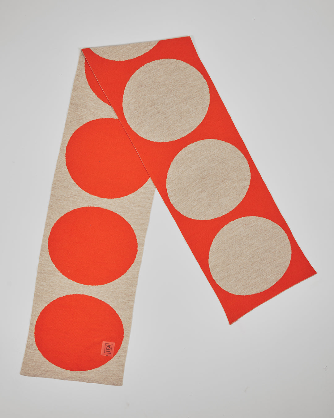 Orange & Cream Dots unisex acrylic scarf flat lay in vivid orange and soft cream