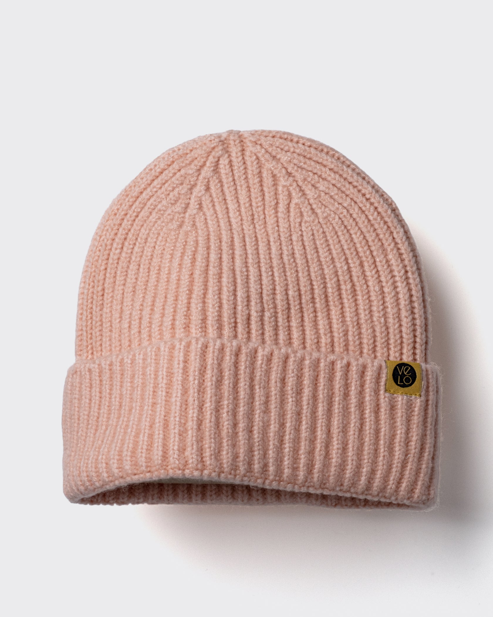 Peach Lux Beanie on a light gray background