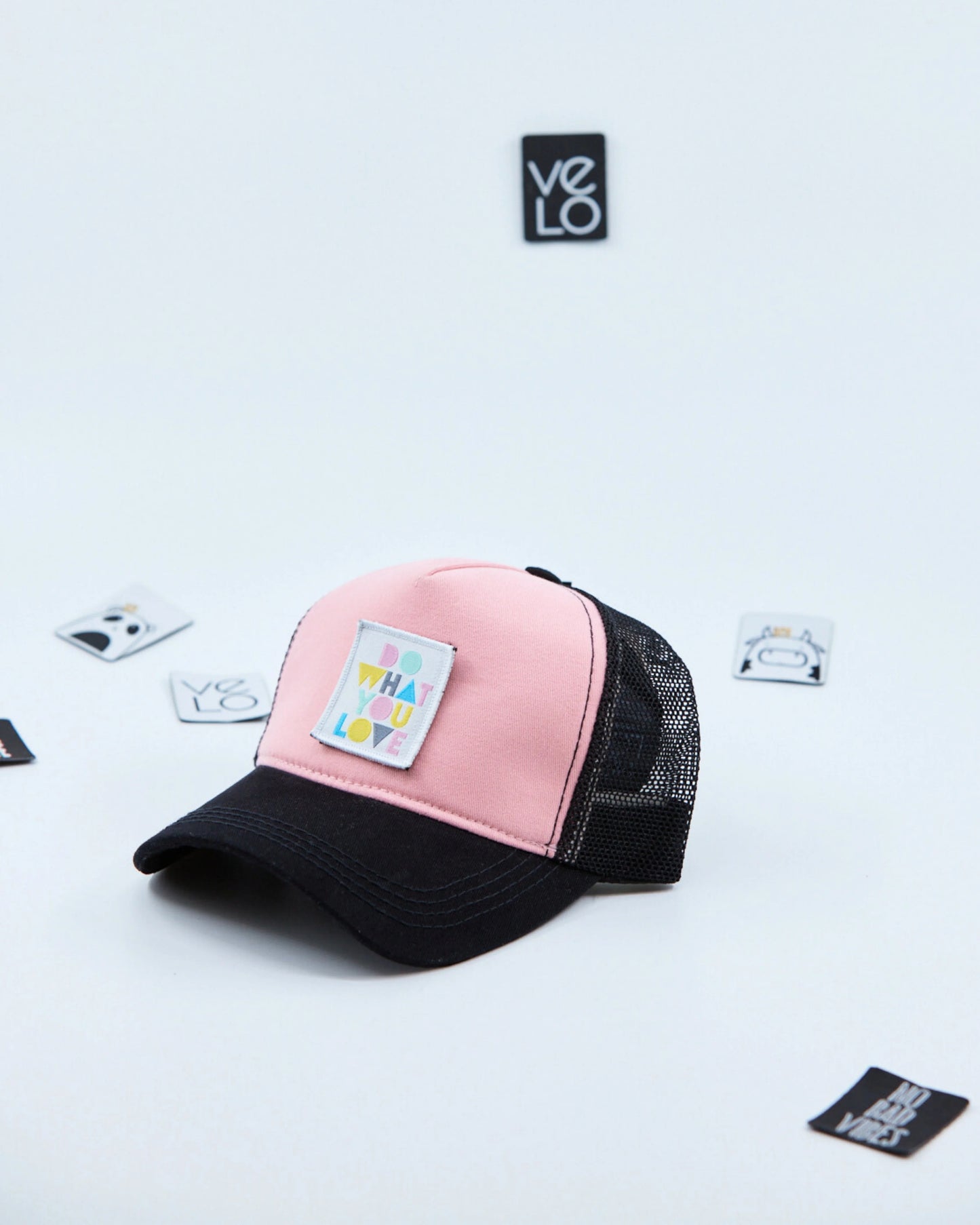 Side view of Pink and Black Customisable Trucker Cap with patches