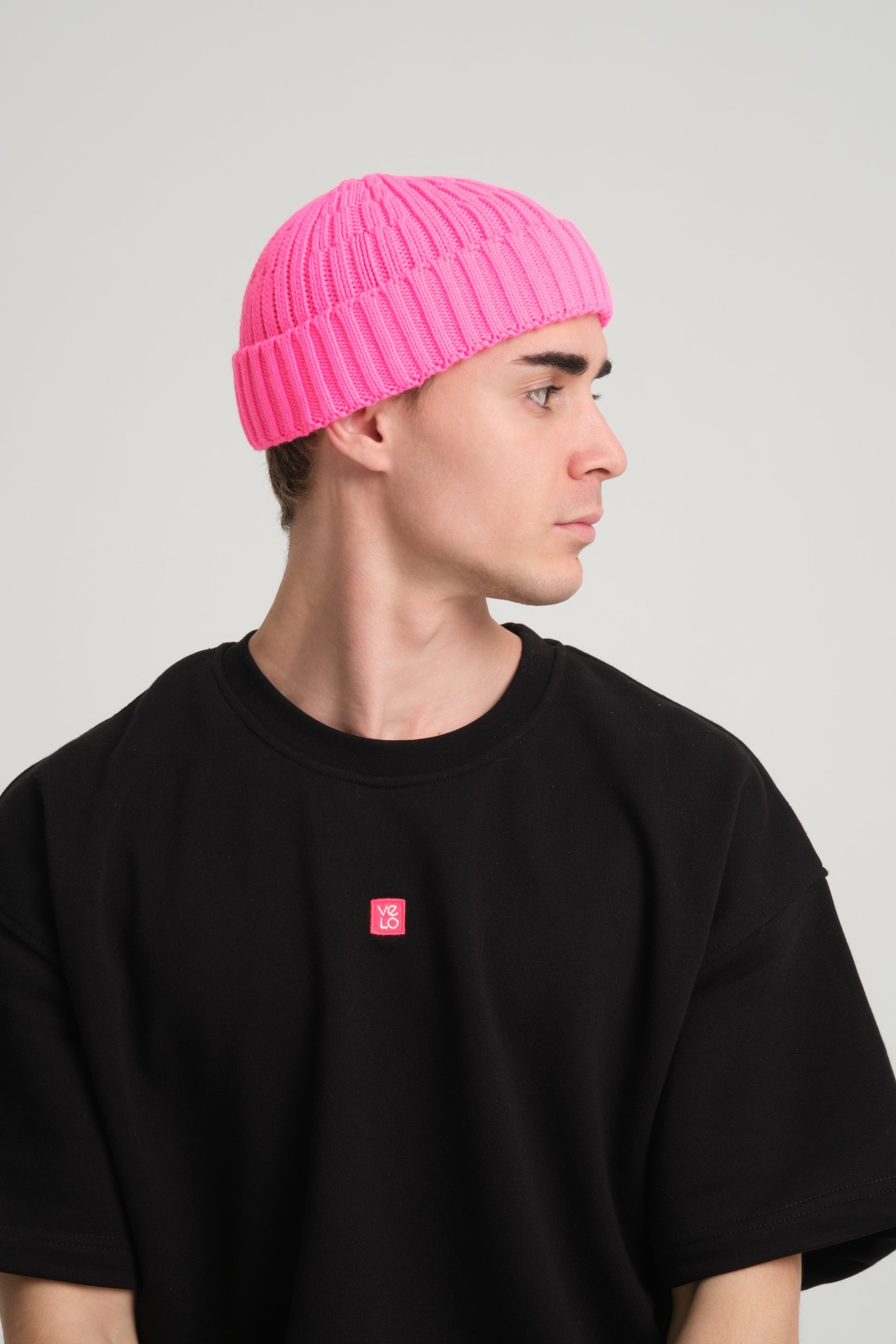side view of a man wearing Fuchsia Fisherman Beanie