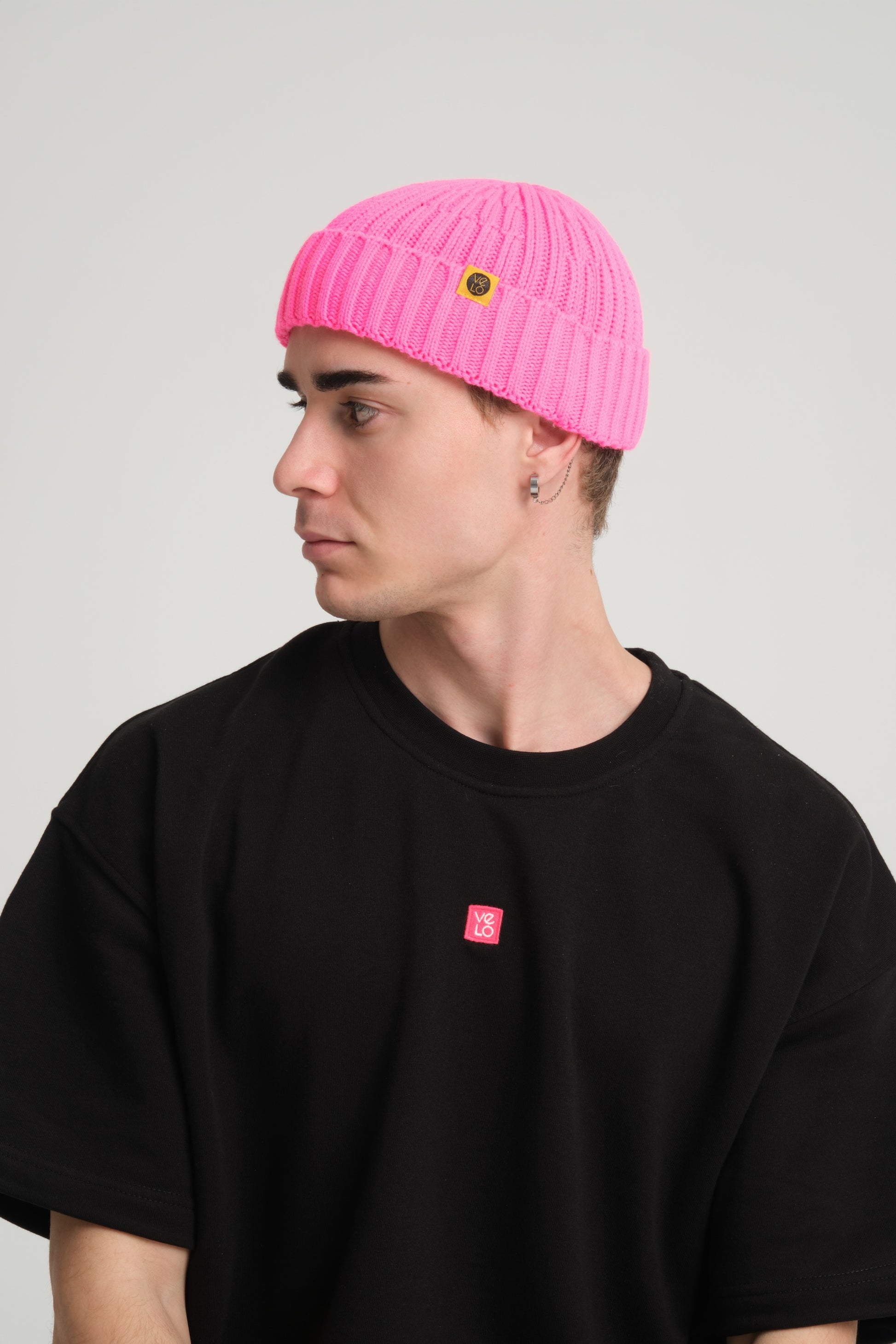side view of a man wearing Fuchsia Fisherman Beanie