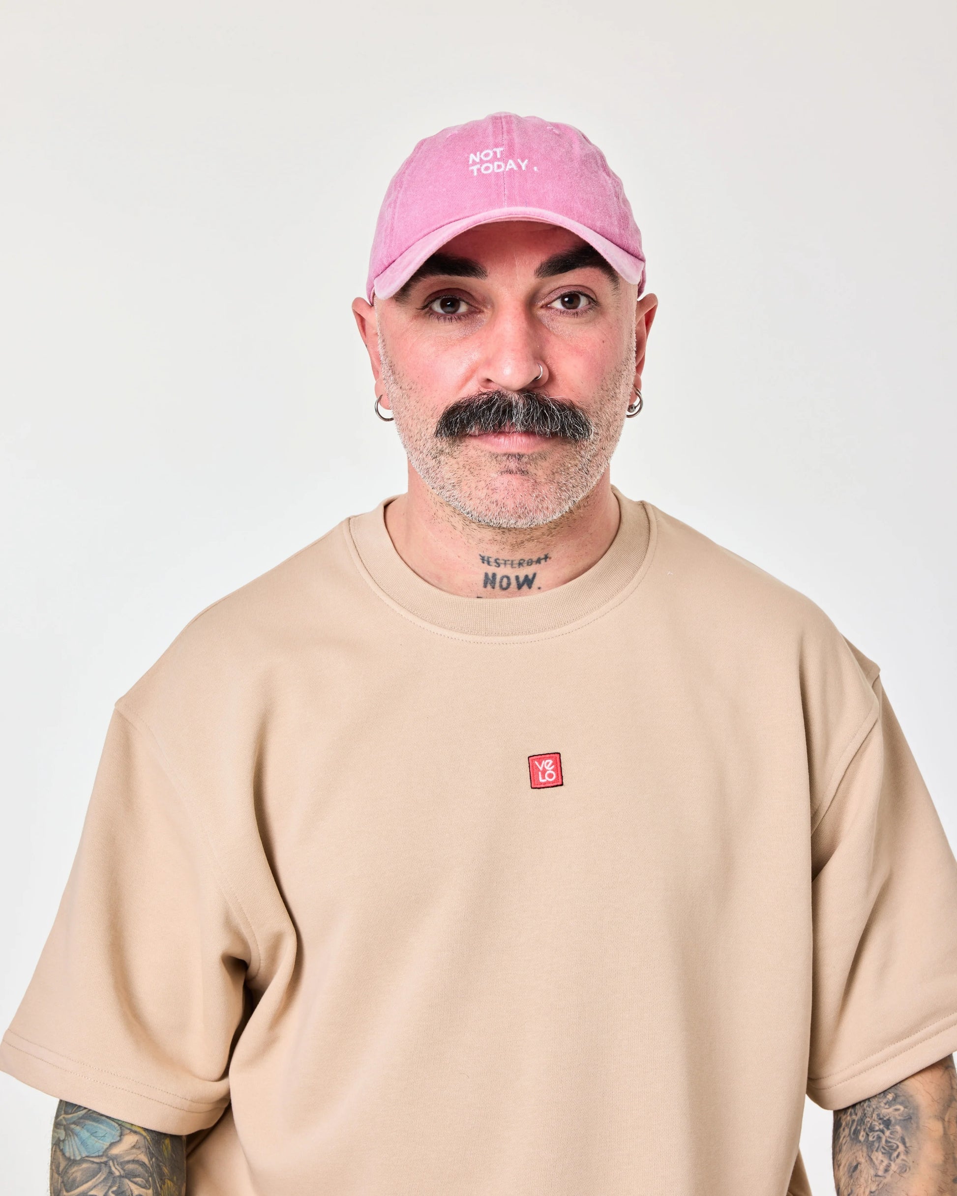 man wearing Pink Washed Cap with Not Today embroidered in white