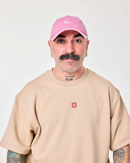 man wearing Pink Washed Cap with Not Today embroidered in white