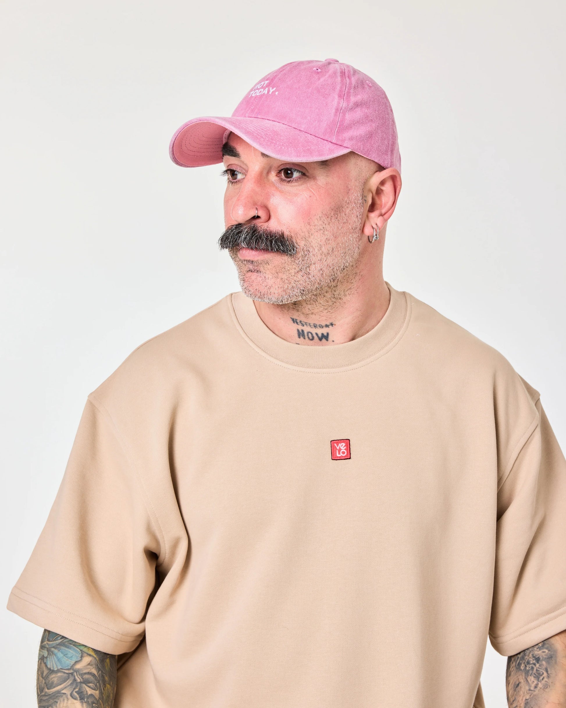 man wearing Pink Washed Cap with Not Today embroidered in white