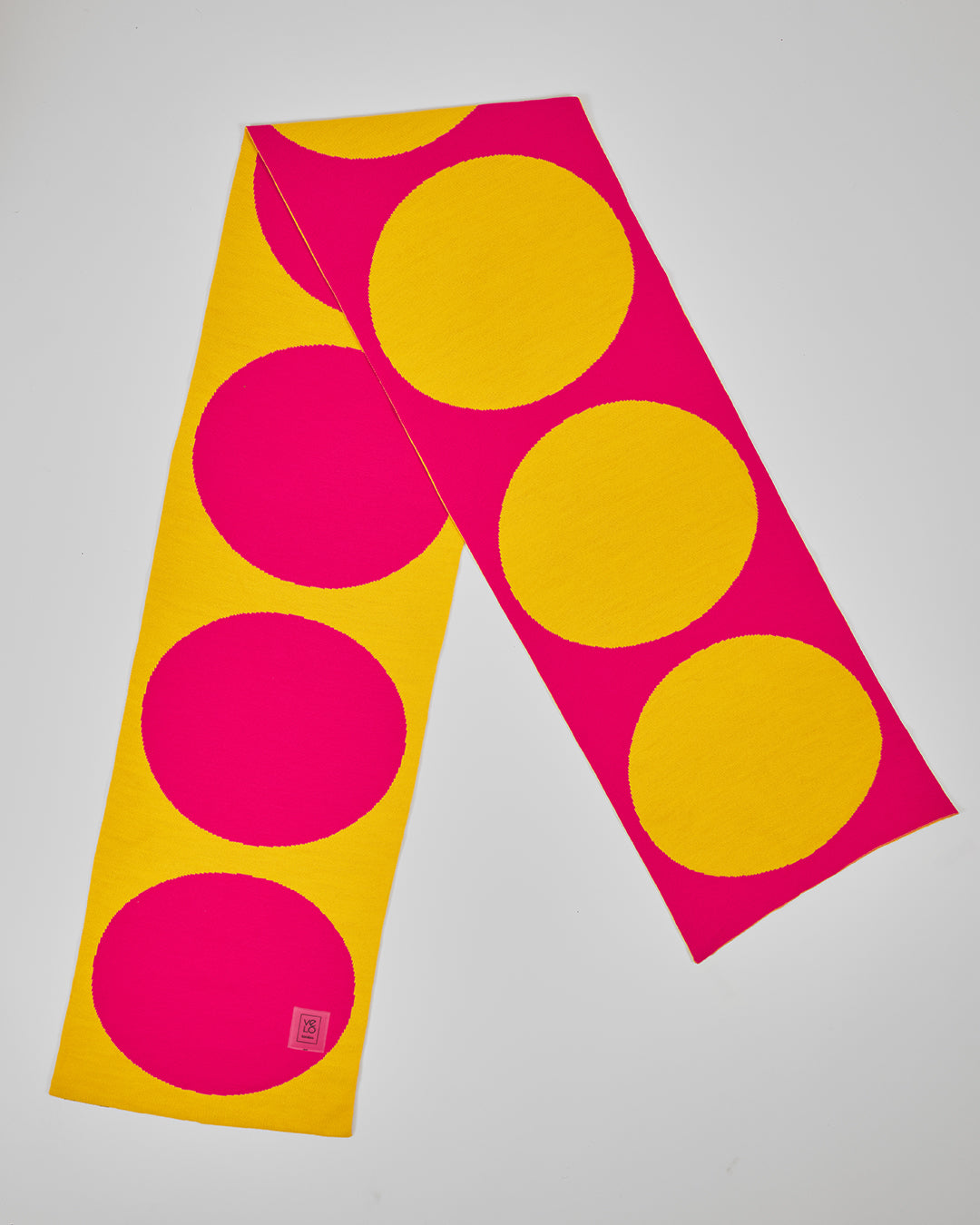 Pink & Yellow Dots unisex acrylic scarf flat lay in electric pink and sunny yellow