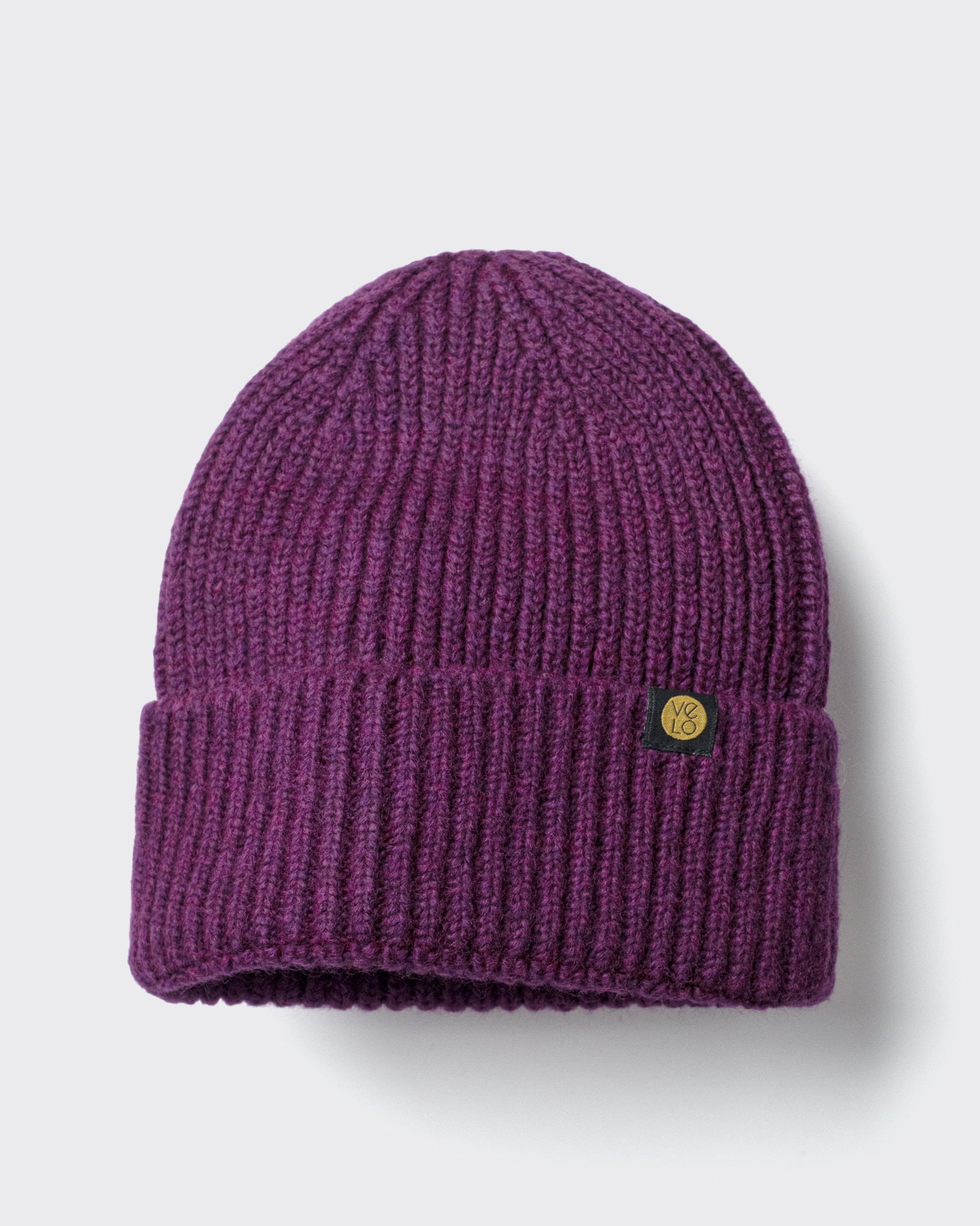 Plum Lux Beanie on a light gray background