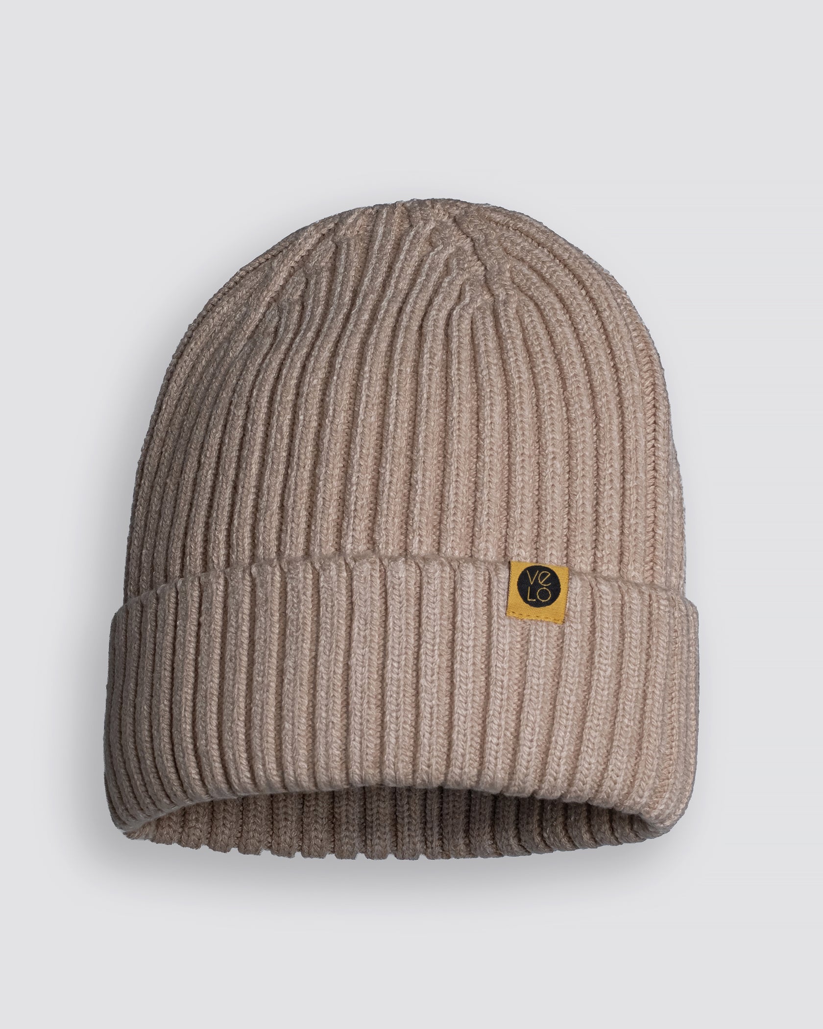 Powder Pink Classic Beanie with a brand logo on a light gray background