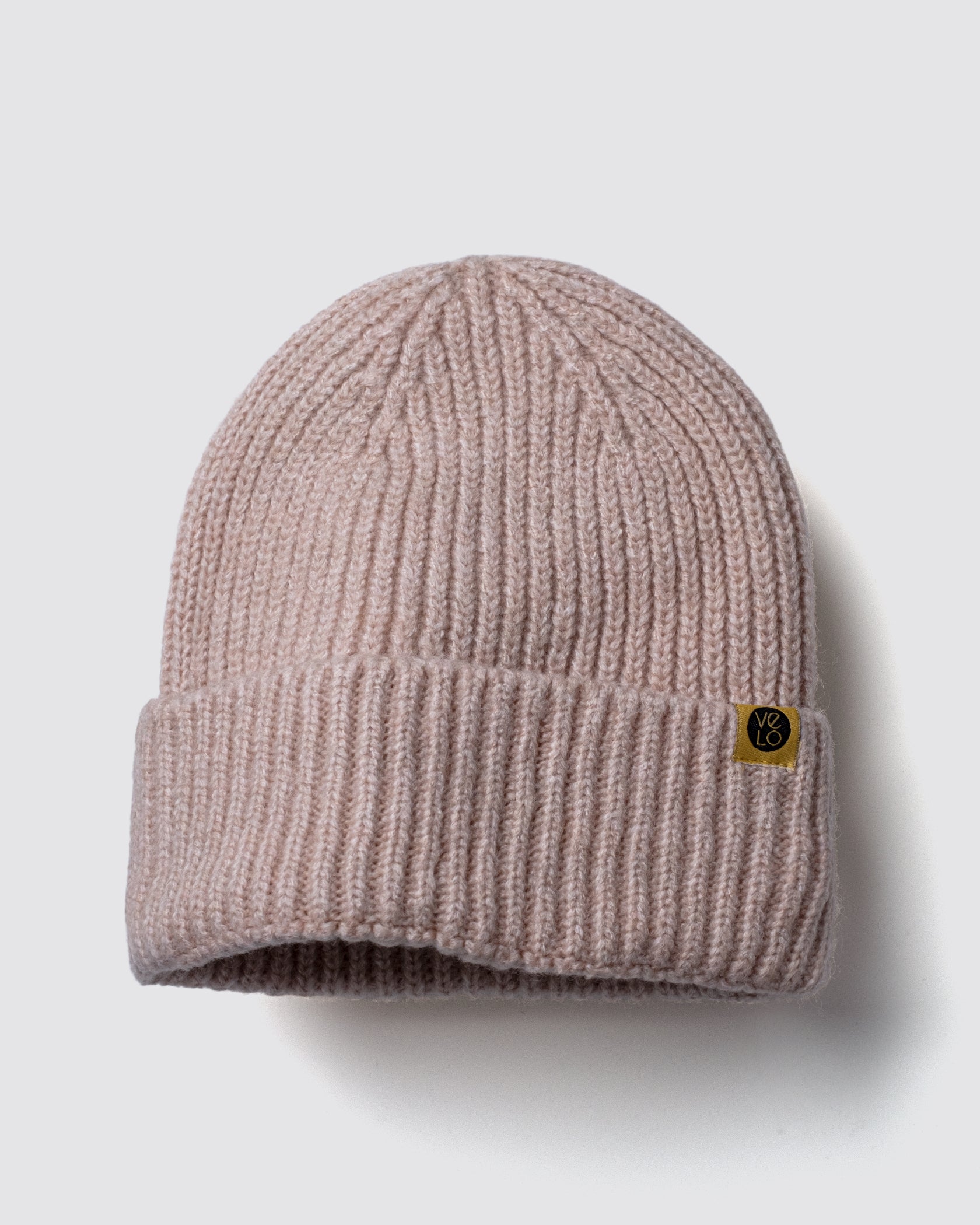 Powder Pink Lux Beanie on a light gray background
