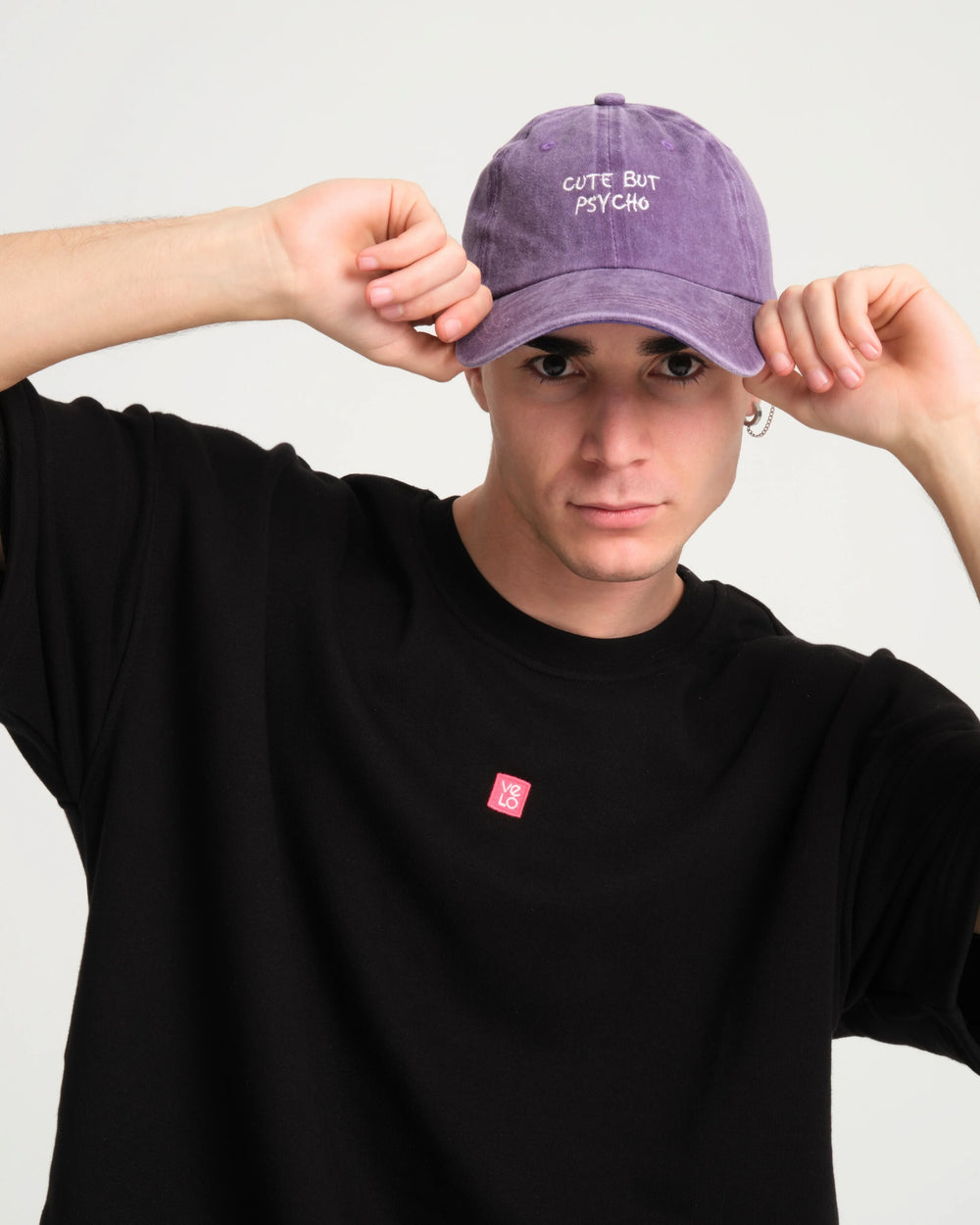 front view of a man wearing Cute But Psycho Purple Washed Cap