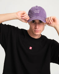 front view of a man wearing Cute But Psycho Purple Washed Cap