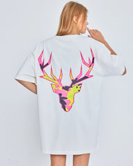 Person wearing a white t-shirt with a colorful deer design on the back against a plain background