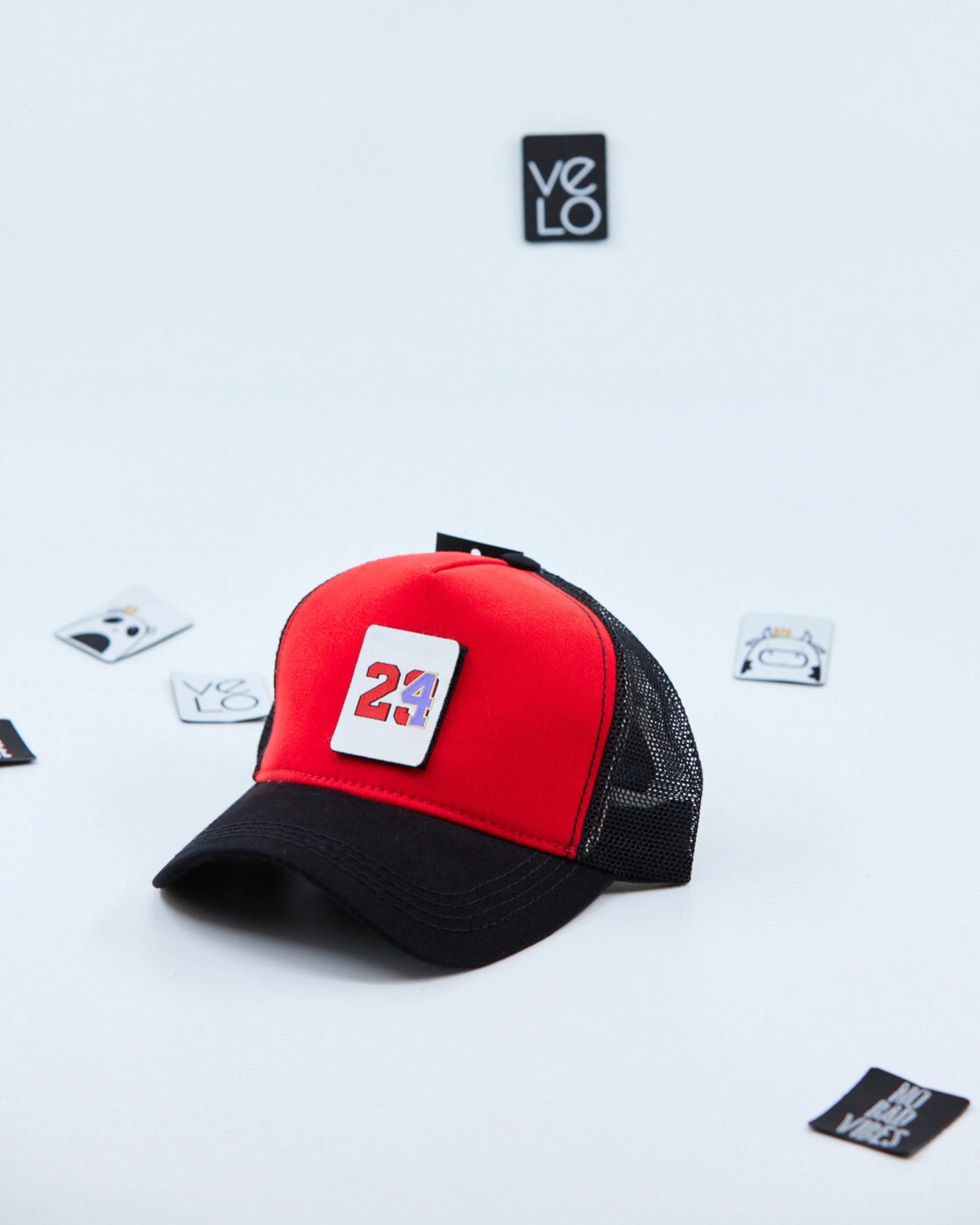 Side view of Red and Black Customisable Trucker Cap with patches