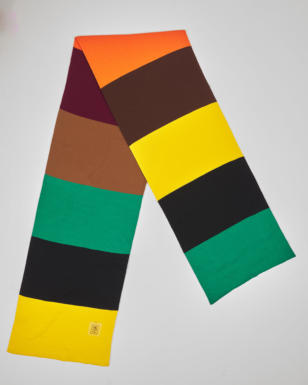 Reggae Vibe unisex acrylic scarf flat lay in green, yellow, orange, black, burgundy and brown