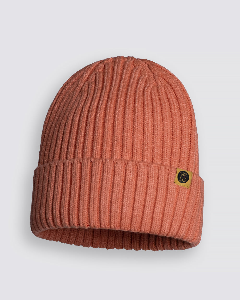 Salmon Classic Beanie with a brand logo on a light gray background