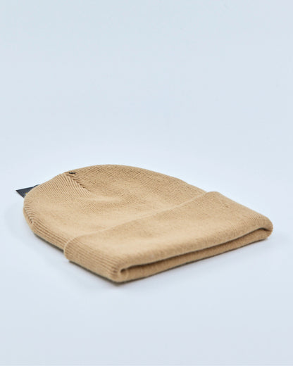Beige beanie on a light gray background
