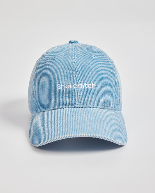 Light blue cap with 'Shoreditch' text on a light gray background