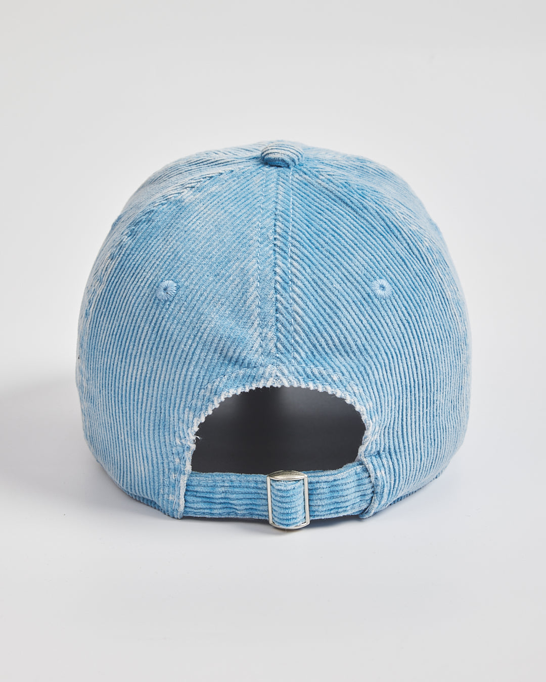 Blue distressed baseball cap on a light gray background