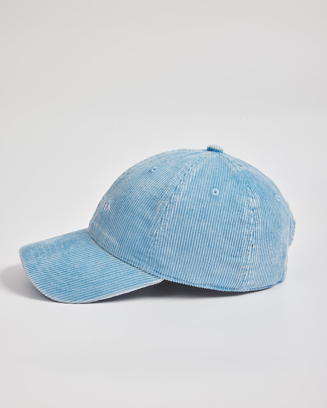 Blue denim cap on a light gray background