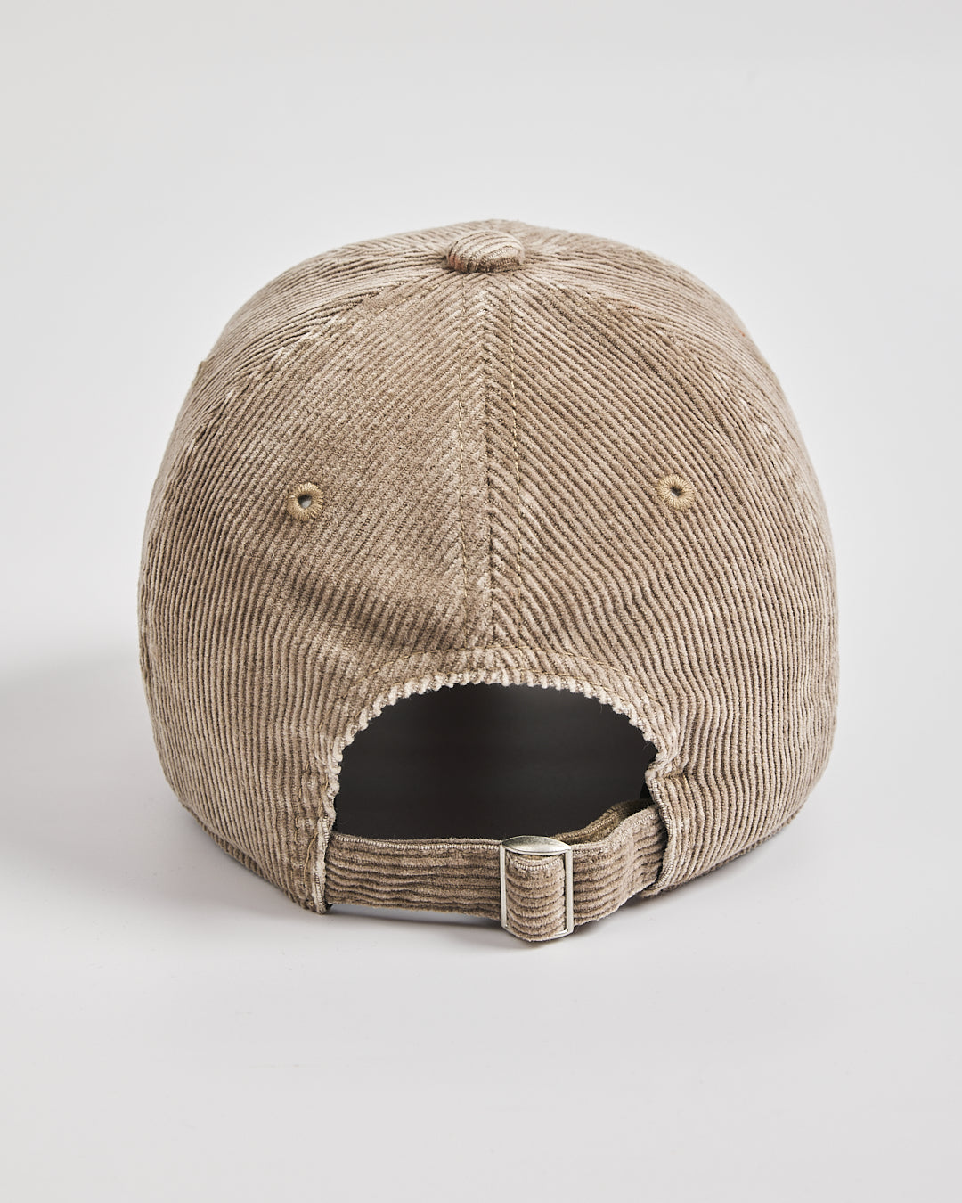 Beige corduroy cap on a light gray background