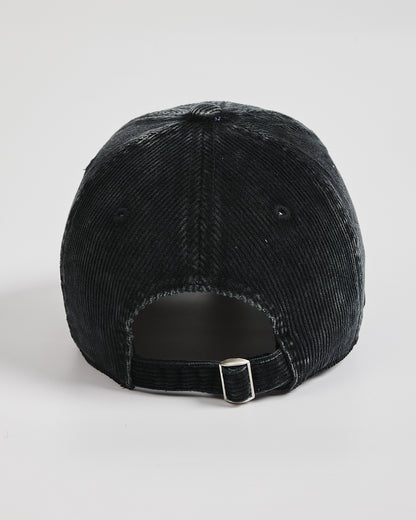 Black corduroy cap on a light gray background